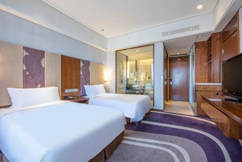 青岛青岛中心假日酒店（五四广场）的酒店客房设有两张床和电视。