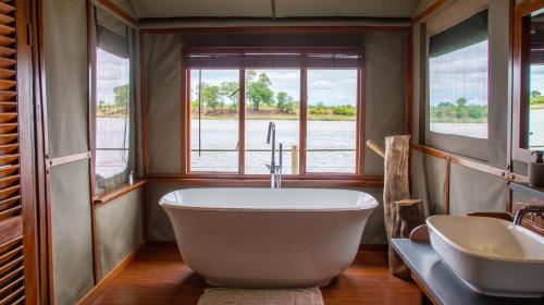 Mahango努霍夫野生动物山林小屋的一间带大浴缸和水槽的浴室