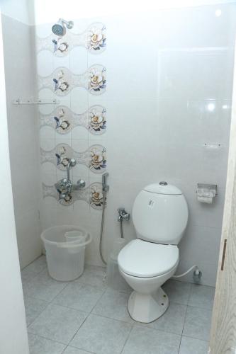 钦奈Swarna Sudarshan Service Apartment @ Adyar chennai的白色的浴室设有卫生间和淋浴。