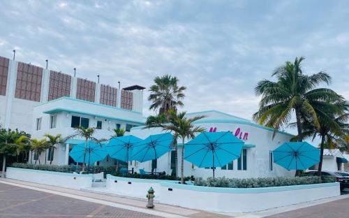 好莱坞The Marlin Beachside的前面有蓝色伞的建筑