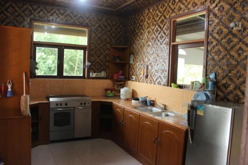 茂物萨拉日出度假屋的厨房配有不锈钢冰箱和水槽