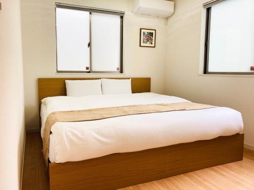 YofukeYofuke House的一间卧室设有一张大床和两个窗户
