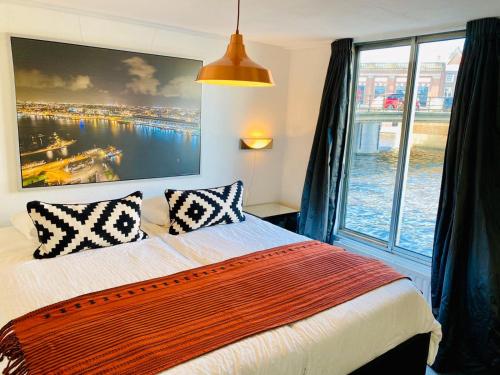 阿姆斯特丹Rembrandt Square Boat的一间卧室设有一张大床和大窗户