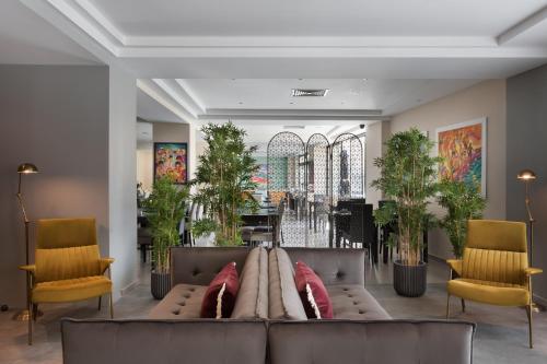 圣朱利安斯Hotel Argento的客厅配有沙发和两把椅子