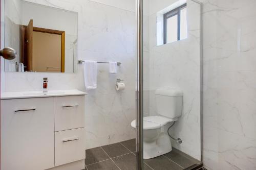 坎伯当曼妮福德汽车旅馆的白色的浴室设有卫生间和淋浴。