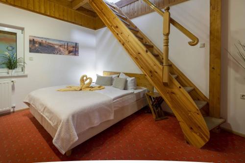 黑灵斯多夫埃德曼加尔尼旅馆的一间卧室设有一张带木楼梯的床。