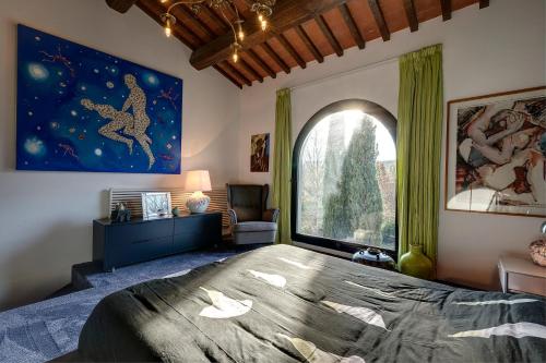 蒙泰卢波菲奥伦蒂诺LE MASSE - LOFT的一间卧室设有一张大床和一个大窗户