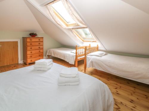 佩恩顿Sea Peeps的阁楼卧室设有两张床和窗户。