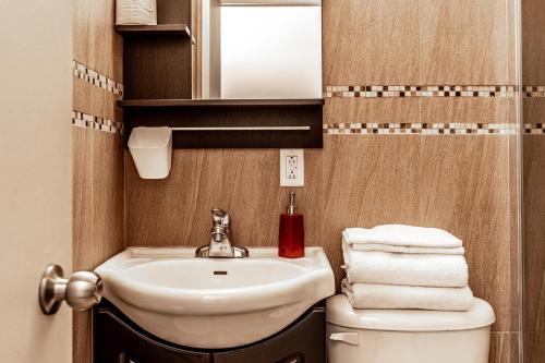 蒙特利尔科珠尔公寓的一间带水槽、卫生间和镜子的浴室