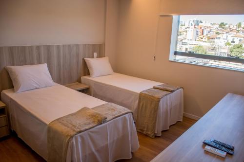 奥利韦拉Boa Vista Hotel的酒店客房设有两张床和窗户。
