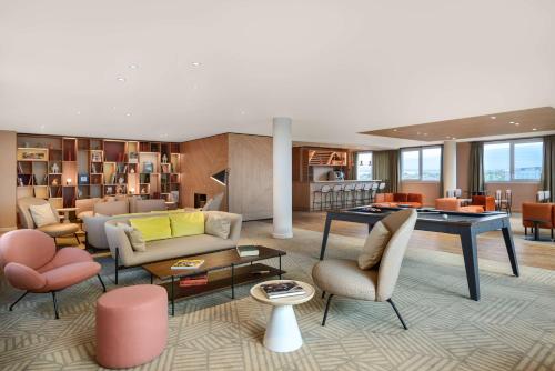 鲁瓦西昂法兰西Hyatt House Paris Charles de Gaulle Airport的客厅配有家具和桌子
