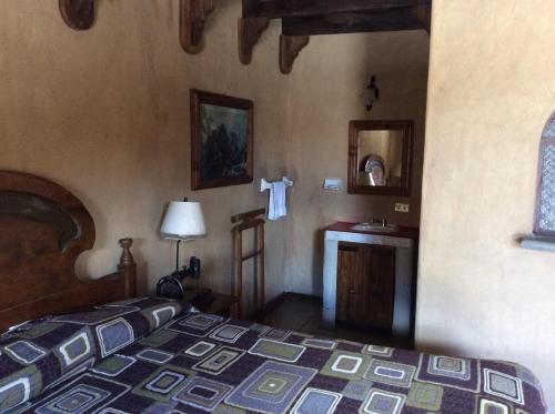 PeroteHosteria Covadonga的卧室配有床和盥洗盆