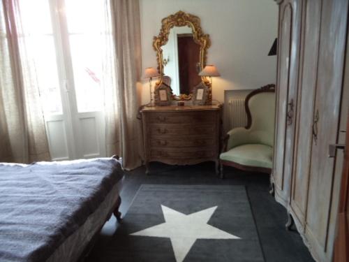 圣让-德吕兹Toki Alai的一间卧室配有一张床、镜子和椅子