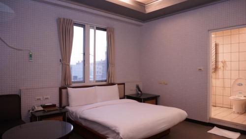 新竹风之海岸旅馆 的酒店客房设有床和窗户。