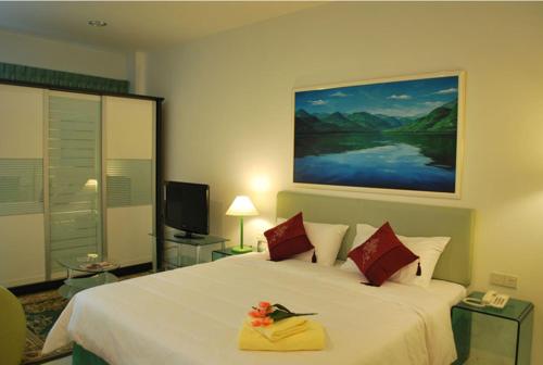 米里MCITI套房酒店的卧室配有带红色枕头的大型白色床