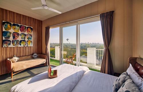 新德里Minimalist One Hauz Khas Village的一间卧室设有一张床和一个大窗户