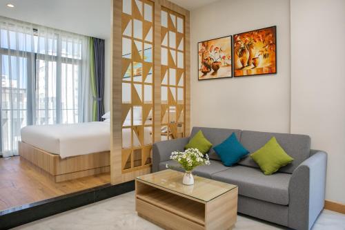 岘港Sun River Hotel & Apartment的带沙发的客厅和卧室