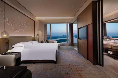 泉州泉州泰禾洲际酒店的卧室配有一张白色大床和电视。