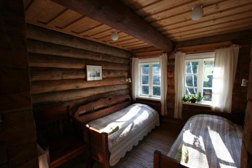 伊格纳利纳米斯基尼柯斯乡村民宿的卧室配有一张床铺,位于带木墙的房间内