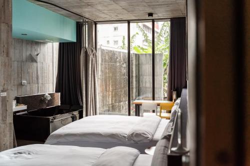礁溪礁溪悠宅SPA会馆的一间卧室设有两张床和大窗户