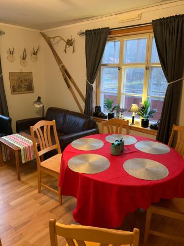 博伦厄Sea Side Cabin的客厅配有红色的桌子和椅子