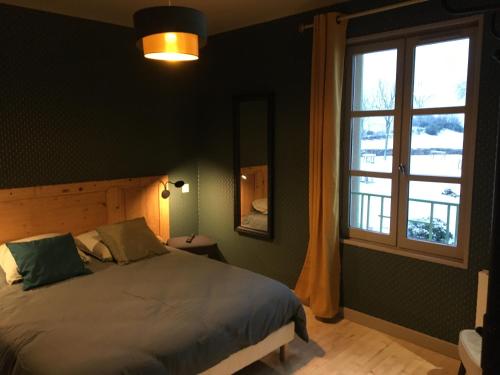 ChamblesEss'folie Gîte的一间卧室设有一张床和一个窗口