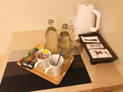 合艾SJ Miracle Hotel的一张桌子,里面装有两瓶,还有一盘饮料