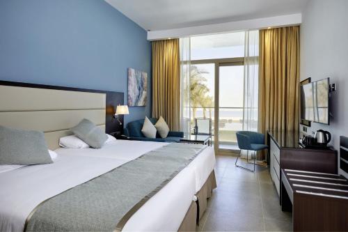 Riu Dubai Beach Resort - All Inclusive客房内的一张或多张床位