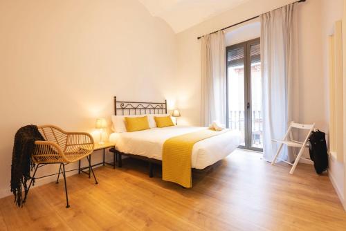 赫罗纳Bravissimo Riu Onyar的卧室配有一张床和一张桌子及椅子