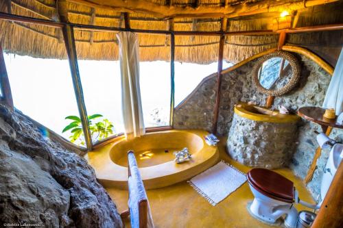 MbitaMfangano Island Lodge的树屋中带浴缸的浴室