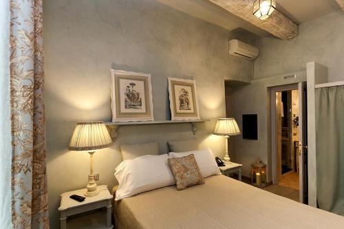 Borgomaro玛罗旅馆的一间卧室配有一张带两盏灯的床。