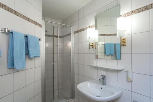 劳芬堡Hotel-Gasthaus Engel Luttingen的白色的浴室设有水槽和淋浴。