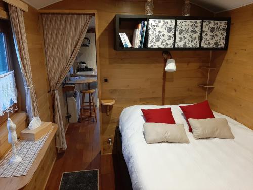 Rebecq-RognonFerme du Grand-Spinois的一间卧室配有红色和白色枕头的床
