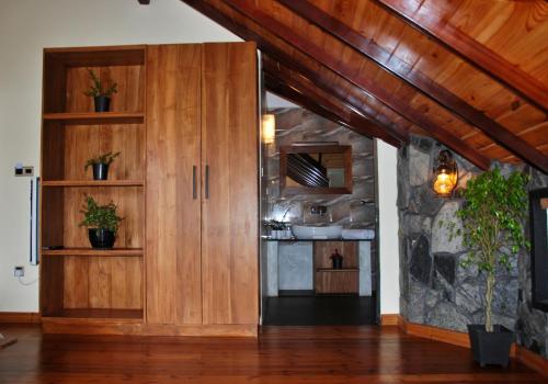 努沃勒埃利耶圣弗朗西斯科度假村的厨房配有木制橱柜和石墙