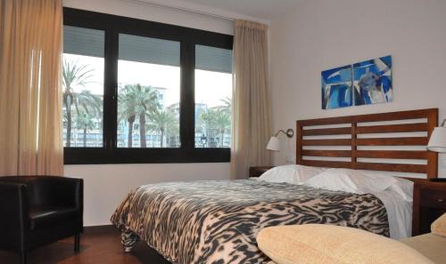 巴塞罗那城堡酒店的一间卧室设有一张床和一个大窗户