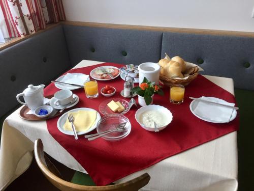 普法尔韦尔芬沃卡里奥旅馆的一张桌子,上面有红色的桌布,上面有食物