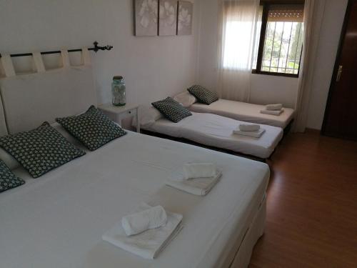 贝纳尔马德纳Chalet Puerto Marina Goya的一间设有两张床铺和毛巾的房间