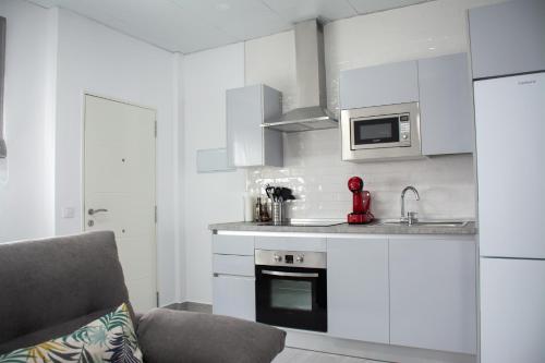 贝赫尔-德拉弗龙特拉Apartamento Calma的厨房配有白色橱柜和炉灶烤箱。