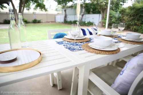 奥兰治桑普森 - 橙色度假屋的一张带玻璃杯和盘子的白色桌子