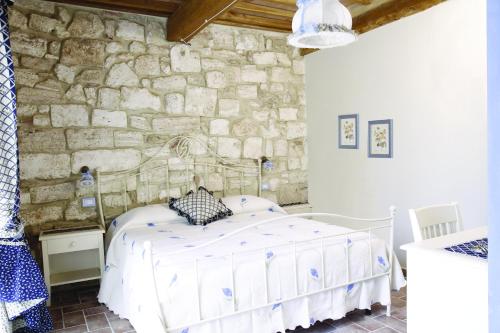塞尔·迪·拉波拉诺圣洛伦索度假农庄的卧室配有一张石墙床