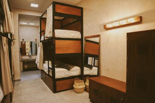 梅里达Hostal Barrio Vivo的客房设有2张双层床和镜子