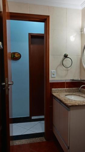 圣保罗Apartamento praia Grande的一间带水槽和棕色门的浴室