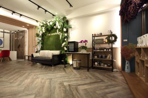 花莲市品 民宿的一间配有沙发的客房和鲜花的绿色墙壁