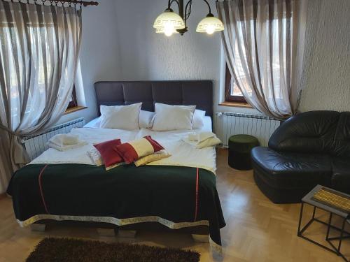 布莱德Apartments & Rooms Florjana的一间卧室配有一张大床和一张沙发