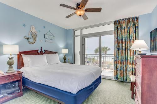 默特尔比奇Atlantica Towers Beach-side Condo w Pools的一间卧室配有一张带吊扇和窗户的床。