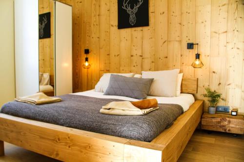 夏蒙尼-勃朗峰Apartment Chinook,La Praz,Chamonix Mont Blanc的一间卧室,卧室内配有一张木床