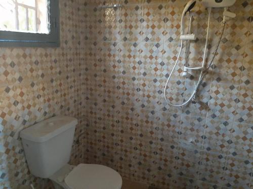 巴马科Villa Chambre A climatisée douche Cuisine salon的带淋浴、卫生间和淋浴头的浴室