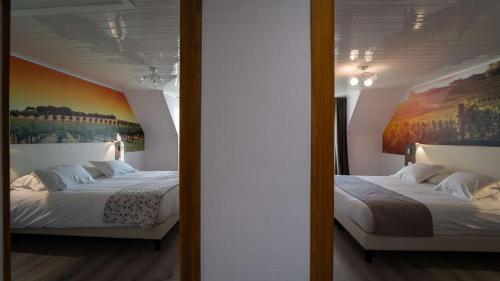 蒂耶里堡法兰西岛贝斯特韦斯特酒店的墙上画画的房间里设有两张床