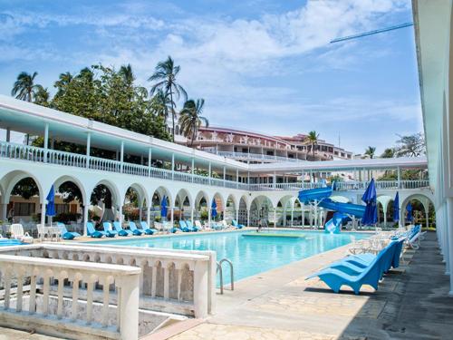 韦拉克鲁斯Collection O Hotel Mocambo, Boca del Río的一座带游泳池和大楼的度假村