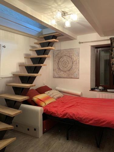AnthyLac et Montagne的一间卧室设有一张床和一个螺旋楼梯